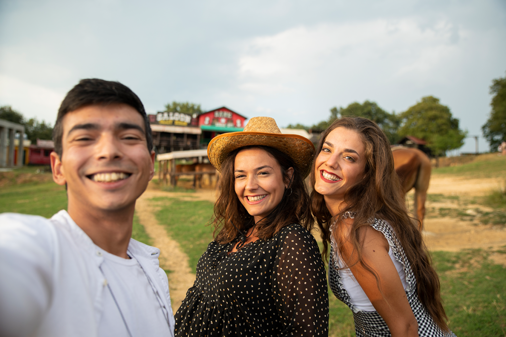 A family posing for a photo at a horse ranch